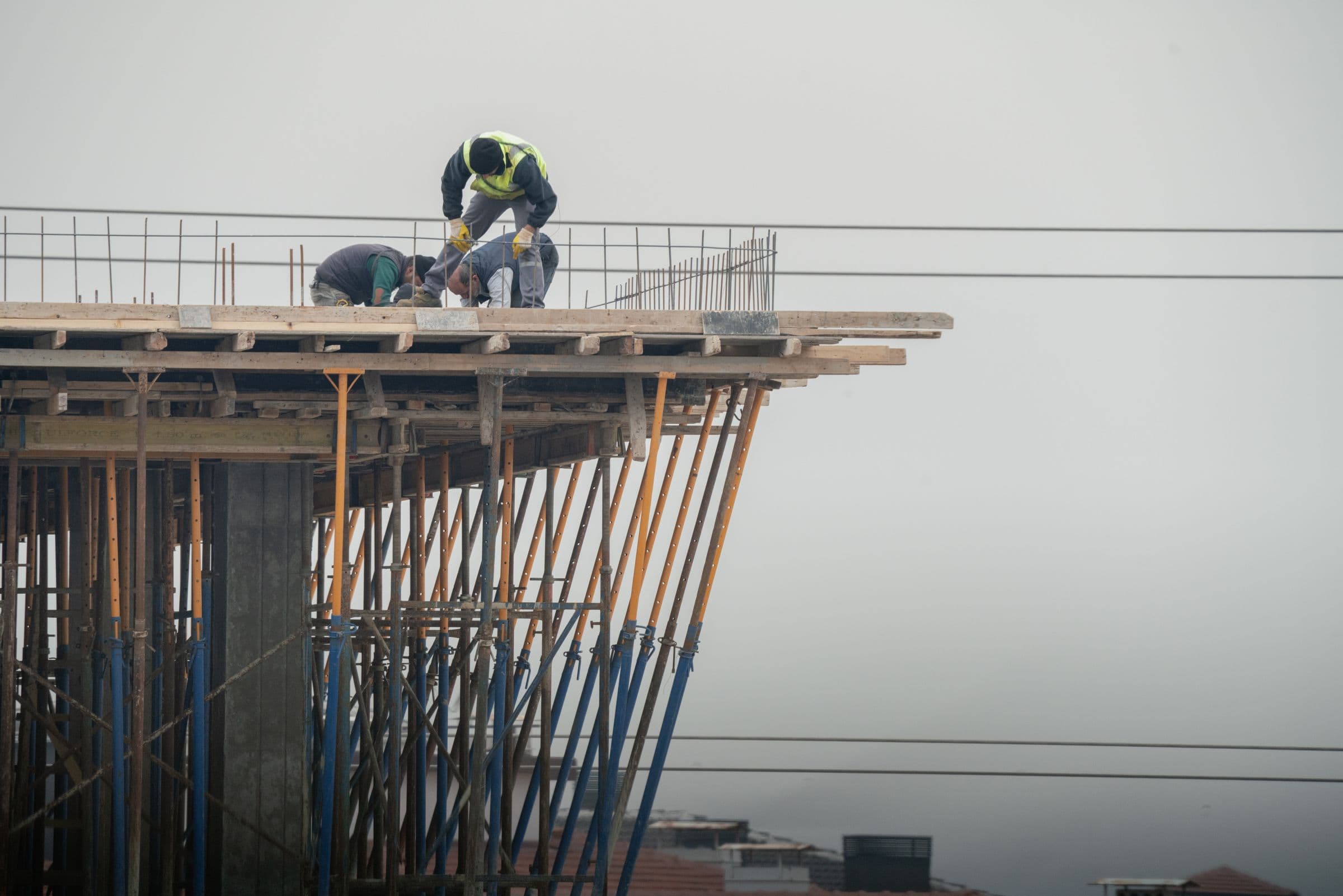 Construction workers on the scaffolding of a high-rise building under construction